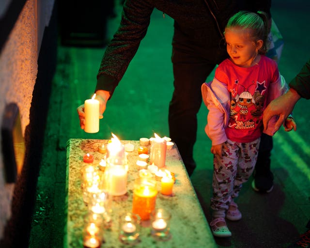 Members of the public light candles as they attend a vigil for the community in Plymouth, Devon (Ben Birchall/PA)