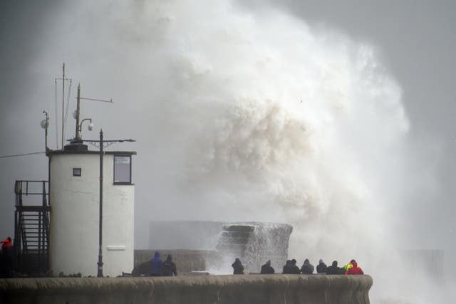 Waves crash over the seafront in Porthcawl