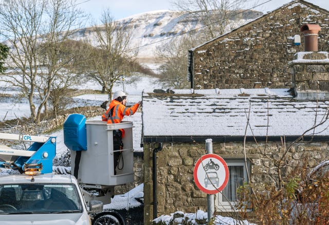 A worker fits an internet cable at a property in North Yorkshire