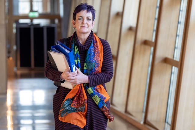 Angela Constance walking through a corridor at Parliament