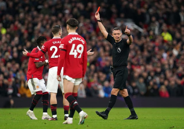 Rreferee Andre Marriner brandishes the red card