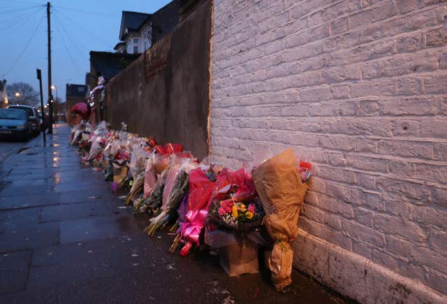 Floral tributes rest against a wall following the  murder of Tanesha Melbourne-Blake in Chalgrove Road, Tottenham (Jonathan Brady/PA).