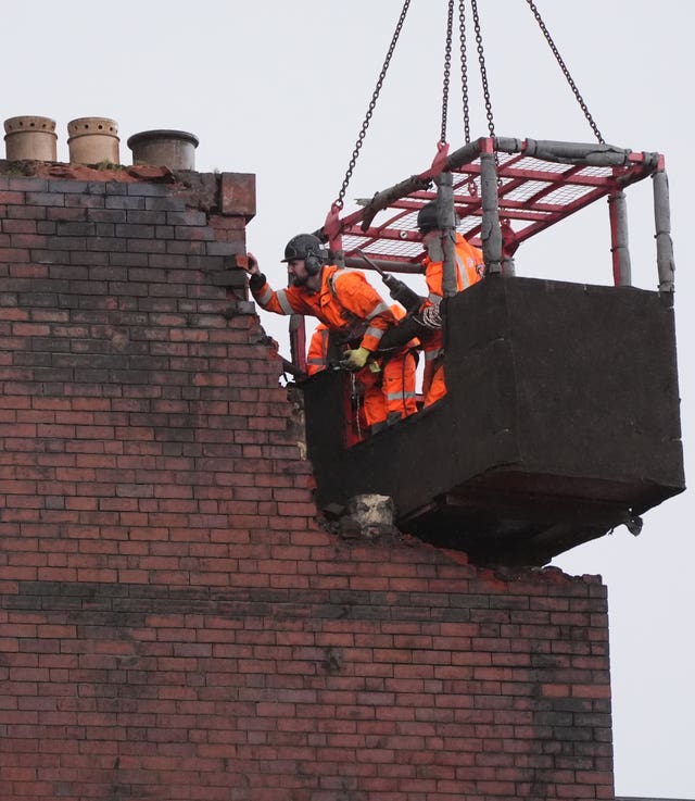 Demolition is carried out on a building destroyed by fire