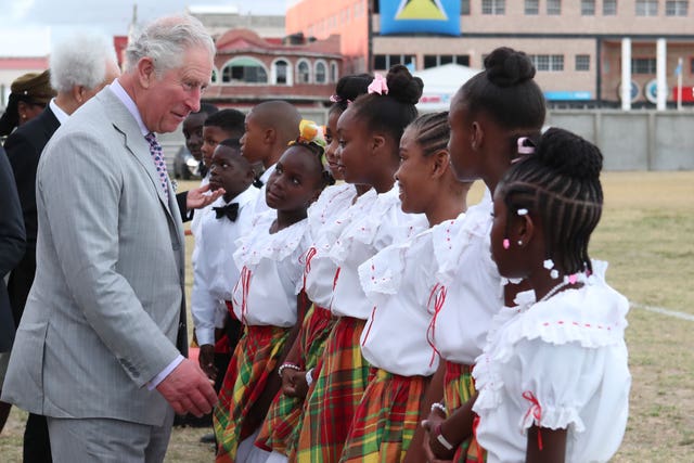 The Prince of Wales talking to dancers at the official welcome ceremony and parade