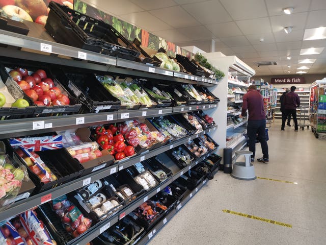 A general view of supermarket shelves of fruit and veg.