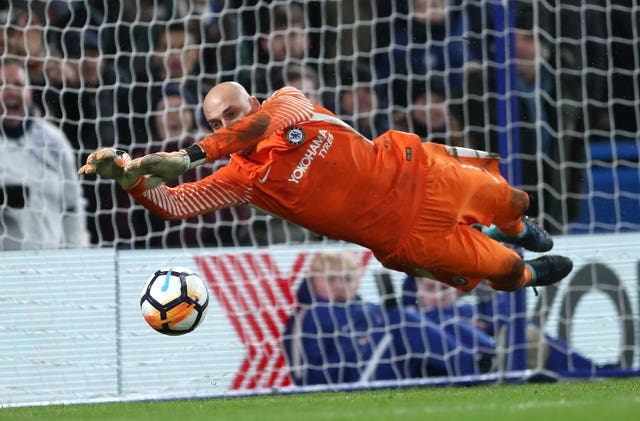 Chelsea goalkeeper Willy Caballero saves Norwich striker Nelson Oliveira's penalty