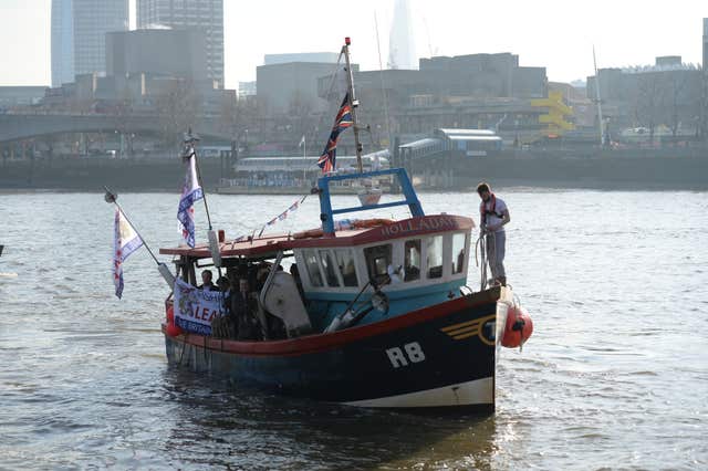 Nigel Farage helped dump fish in the Thames as part of the demo, in support of fishing communities (Stefan Rouseau/PA)