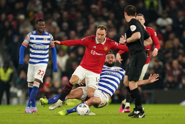 Christian Eriksen, left, suffered an ankle injury after this tackle by Andy Carroll (Martin Rickett/PA)