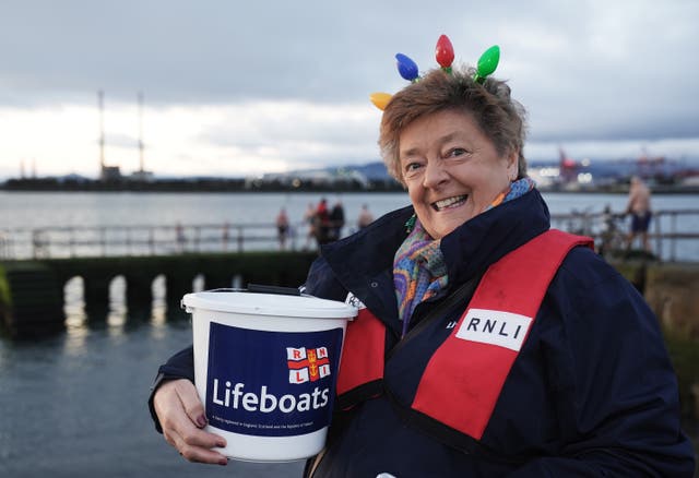 A woman with an RNLI collection bucket