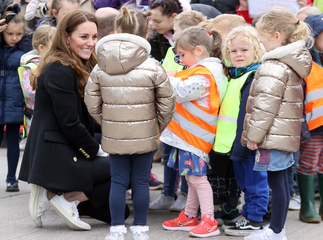 Kate speaks with young children during a meeting (Chris Jackson/PA)