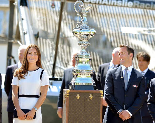 The Duchess of Cambridge with Sir Ben Ainslie in front of the America’s Cup during a visit to the National Maritime Museum, London