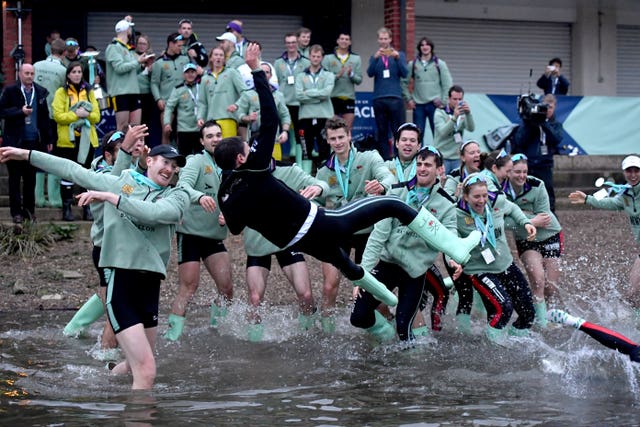 Cambridge University Boat Club president Hugo Ramambason is thrown in the water by team-mates after the men’s Boat Race on the Thames