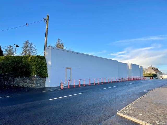 White painted wall along the side of a road