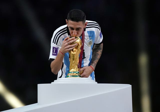 Di Maria kisses the World Cup trophy after Argentina's victory over France in Qatar last year 