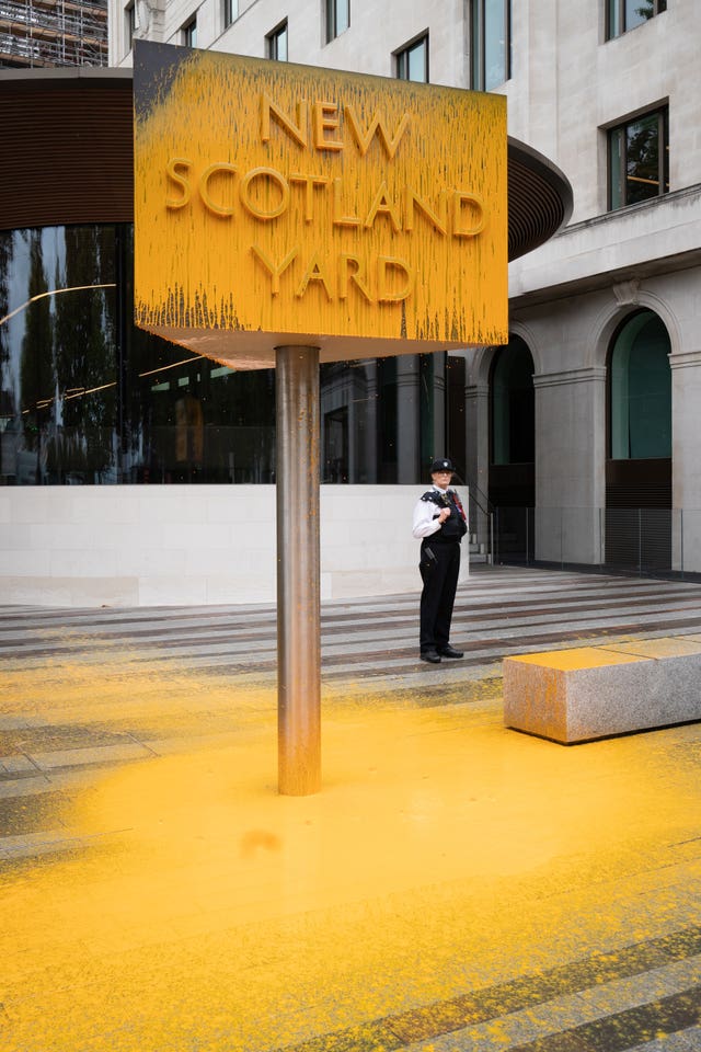 The sign outside New Scotland Yard in London was covered in yellow paint (Stefan Rousseau/PA)