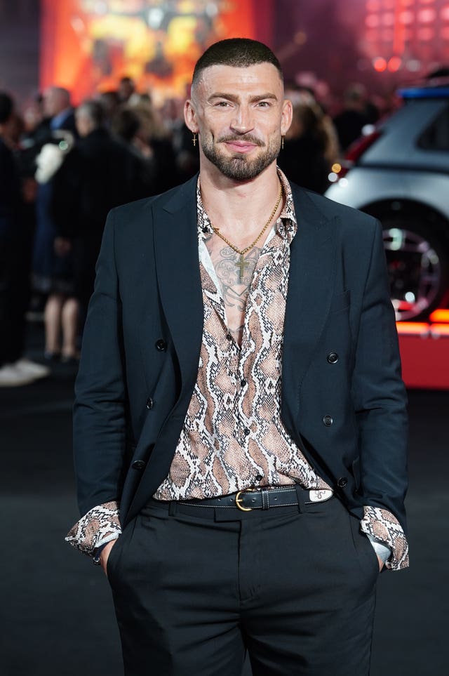 Jake Quickenden smiling while posing for photos at a red carpet event