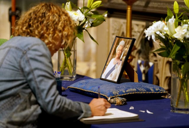 Mourners sign the book condolence at Canterbury Cathedral in Kent