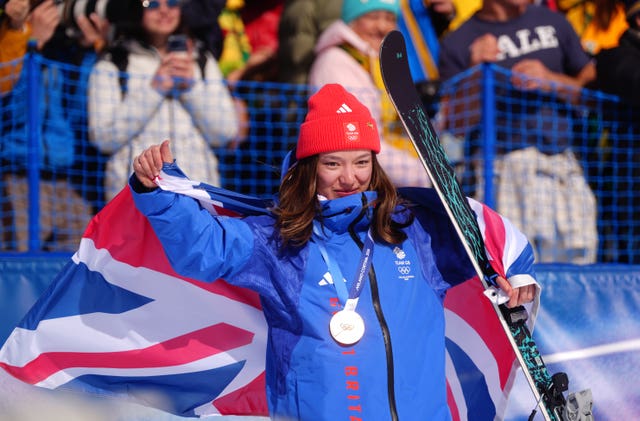 Zoe Atkin wears her bronze medal while raising a Union flag
