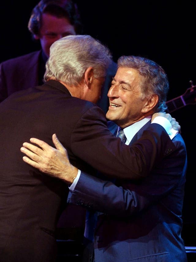 Singer Tony Bennett (right) receives a hug from former US president Bill Clinton during A Night At The Apollo (Stan Honda/PA)