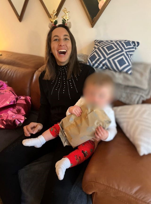 Amie Gray with a baby with its face blurred