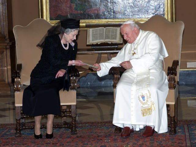 Queen Elizabeth II exchanging letters with Pope John Paul II during an audience at the Vatican in Rome in 2000