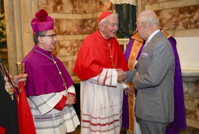 Charles is greeted by cardinal Vincent Nicholls as he arrives for an advent service