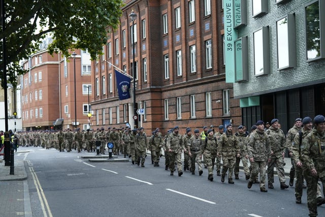 Members of the armed services walking down Horseferry Road to get into position