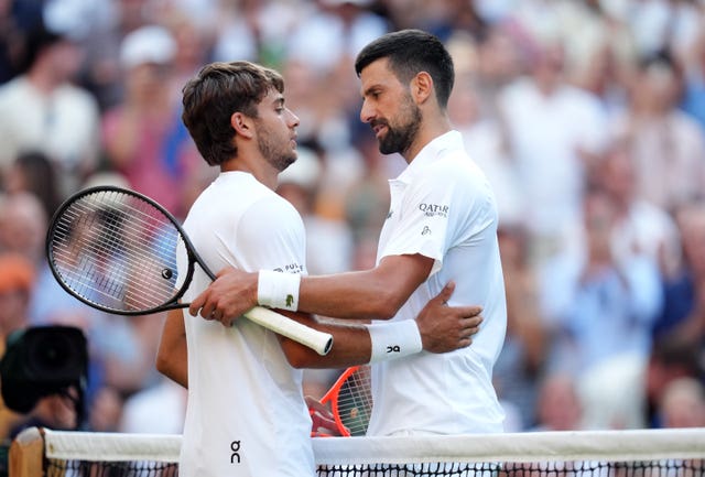 Novak Djokovic (right) shakes hands with Flavio Cobolli