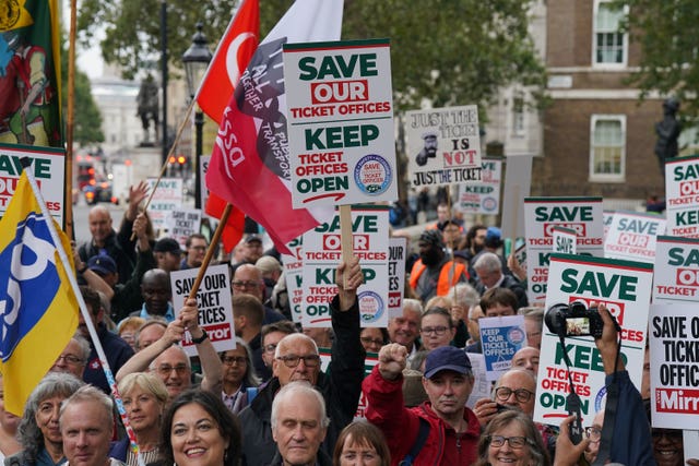 People take part in a protest organised by the Rail, Maritime and Transport union (RMT) opposite Downing Street, London, over the proposed closure of railway station ticket offices