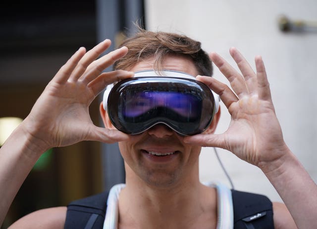 A man wearing an Apple Vision Pro mixed reality headset