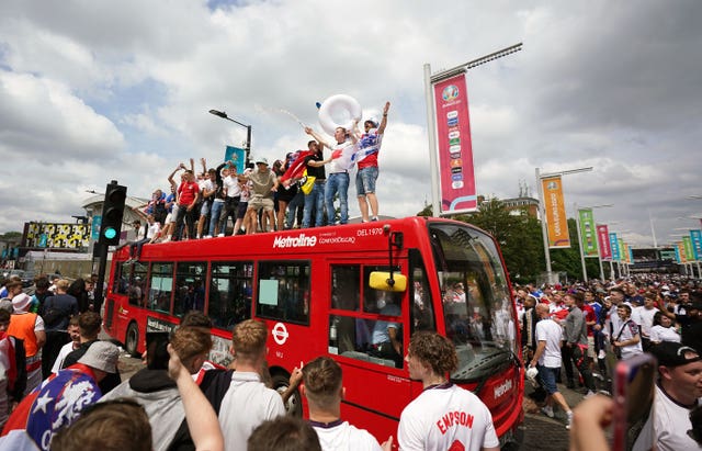 England fans climb aboard a bus outside the ground ahead of the Euro 2020 final at Wembley. The day was marred by crowd trouble with ticketless thugs storming into the stadium before kick-off 