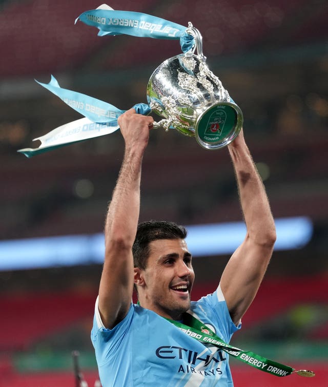 Manchester City’s Rodri raises the Carabao Cup above his head