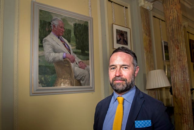Artist Gareth Reid with the portrait 