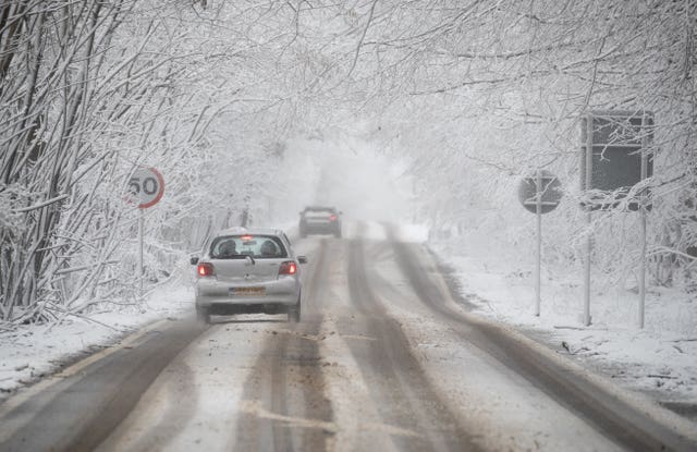 A car makes its way along a snow-covered A252 near to Charing in Kent