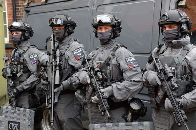 Counter-terrorist firearms officers in full kit holding their weapons.