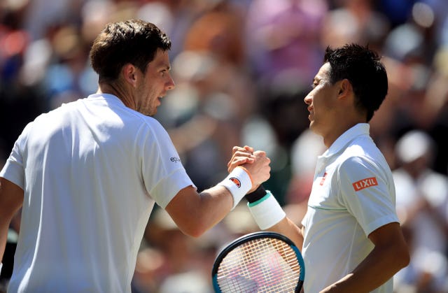 Cameron Norrie (left) shakes hands with Kei Nishikori after his second-round loss
