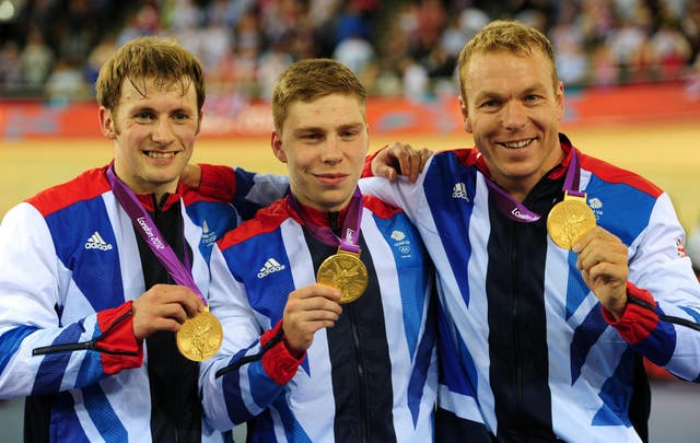 Hoy, right, Jason Kenny, left, and Philip Hindes proudly display their team sprint gold medals 