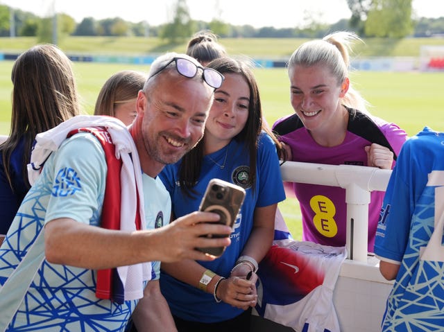 England’s Alessia Russo takes pictures after a training session at St George’s Park, Burton upon Trent.