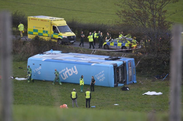 The school bus on its side in a field after the crash