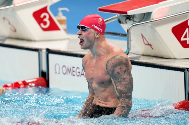Adam Peaty celebrates his second Olympic 100 metres breaststroke title