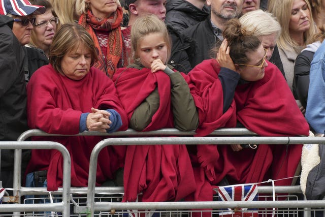Members of the crowd react during the Queen's funeral
