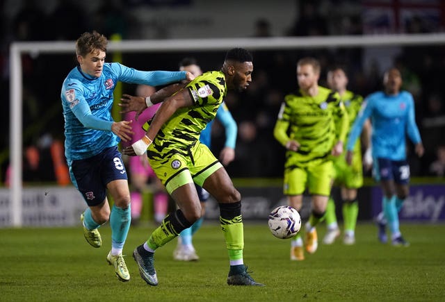 Forest Green Rovers’ Jamille Matt, right, hold off Exeter’s Archie Collins