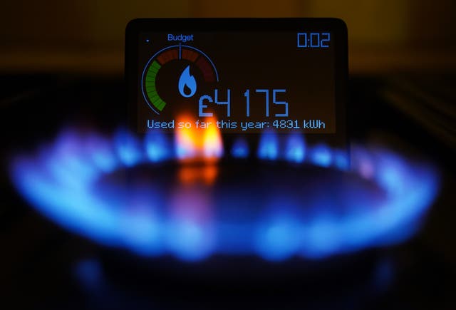 A handheld smart meter on a kitchen hob
