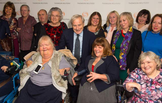 Sir Harold Evans with a group of thalidomide victims at the premiere of Attacking The Devil