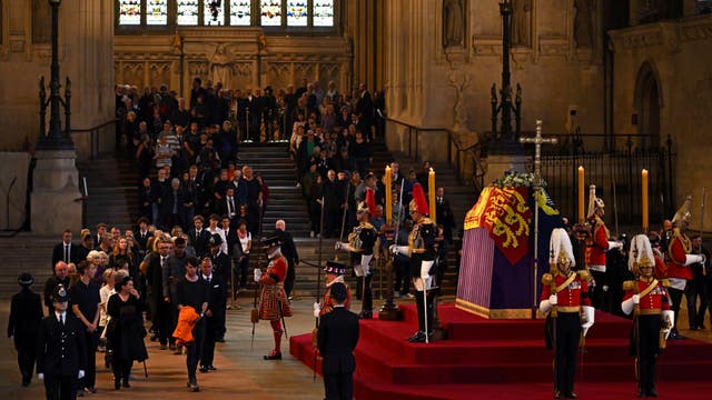 Members of the public pay their respects as the vigil begins around the Queen's coffin