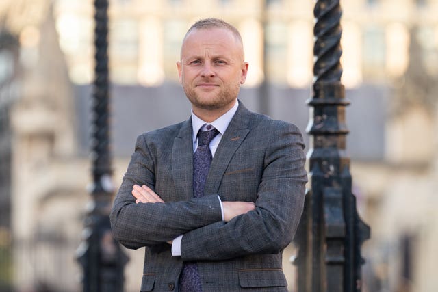 Loyalist activist Jamie Bryson smiles at the camera