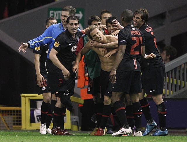Aguero, third right, joins the celebrations after the shirtless Diego Forlan fired Atletico into the final