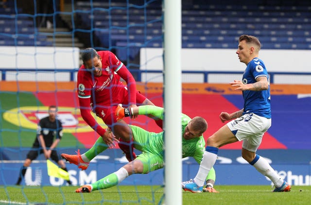 Jordan Pickford's challenge on Virgil Van Dijk, left, went unpunished