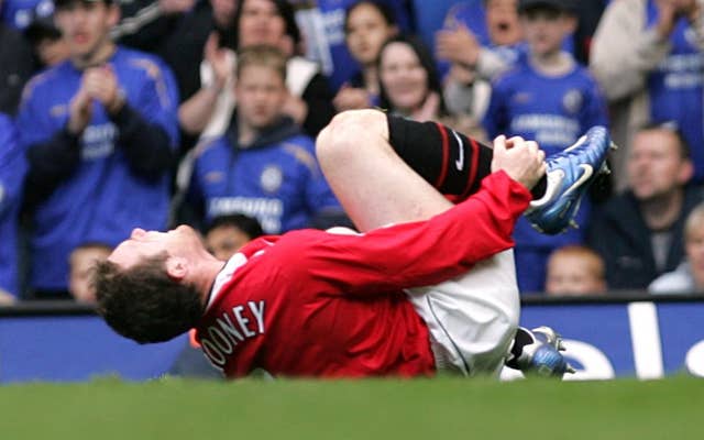 Wayne Rooney writhes around in pain at Stamford Bridge