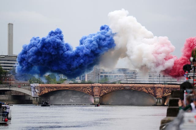 Smoke in the colours of the flag of France rises above the Pont d'Austerlitz at the Paris 2024 Olympic Games opening ceremony